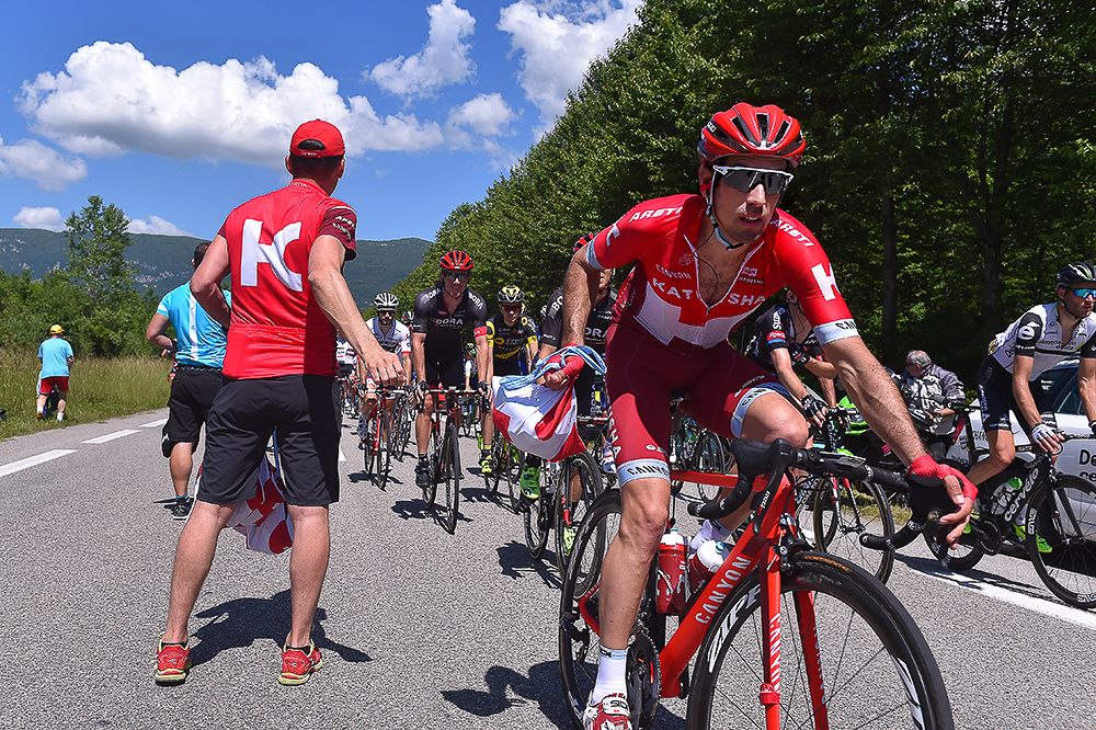 A Katusha rider takes on supplies in the feed zone.