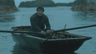 Gendry rowing a boat in a scene from Game of Thrones.