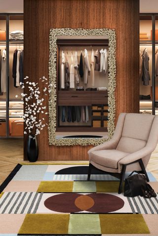 Large closet with cream armchair and patterned rug