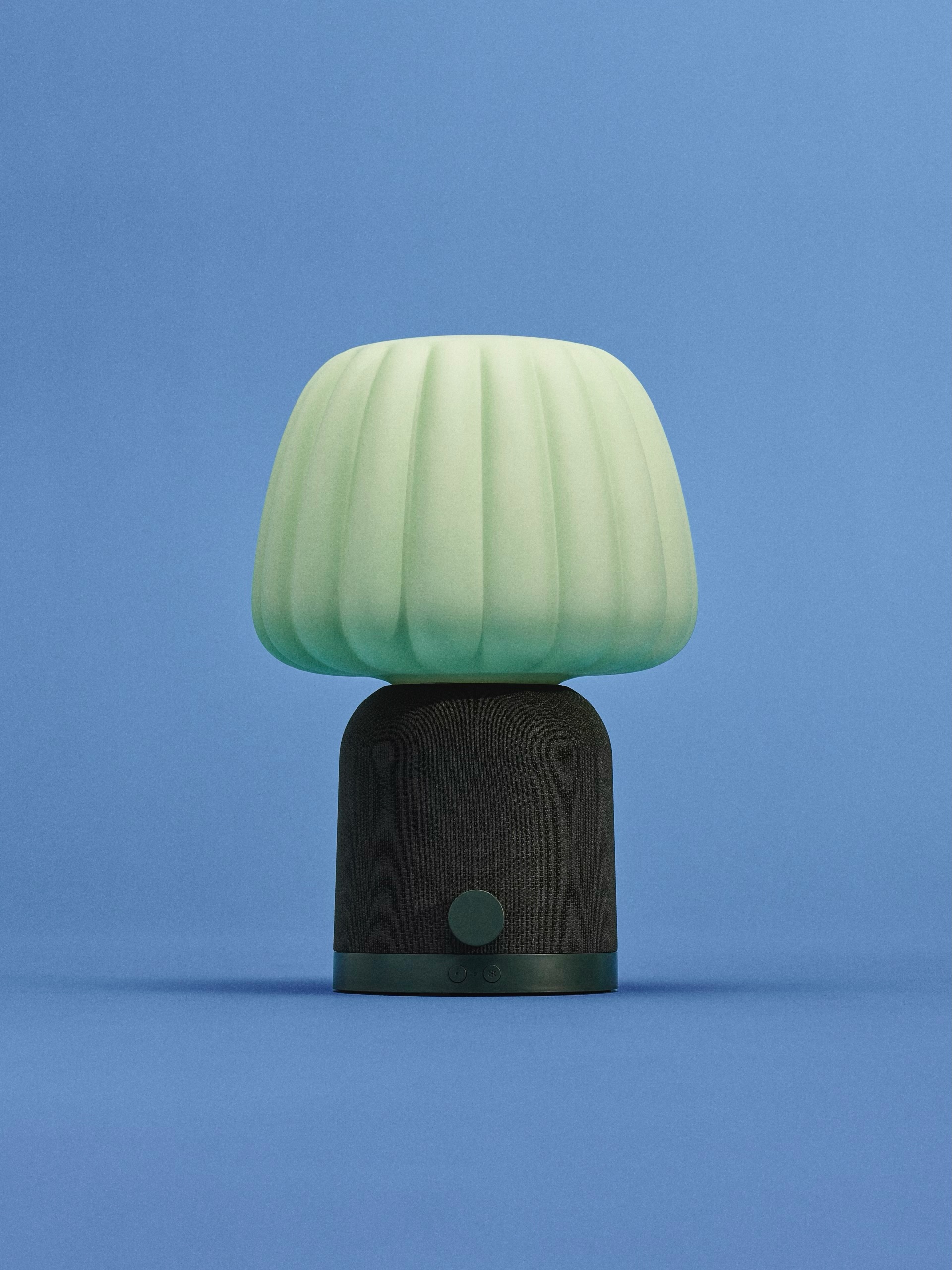 mint green speaker lamp with ice cream-inspired glass shade on a blue background
