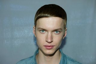 male model head shot with slick hair and blue eyes