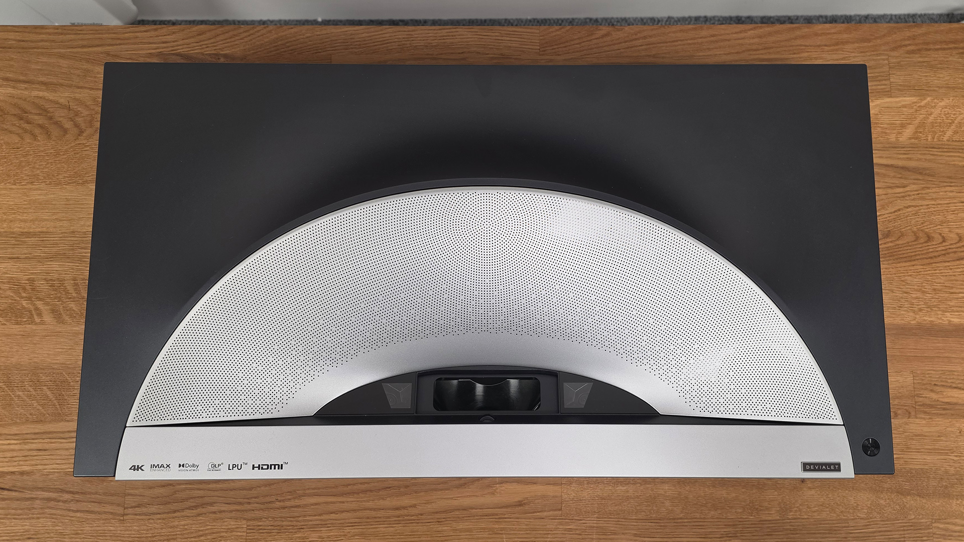 Hisense PX4 Pro UST projector on wooden AV rack viewed from above