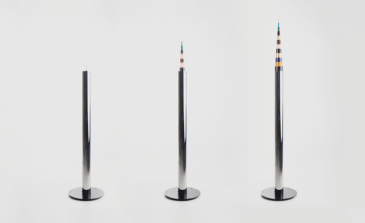 Moving cylinders that tell the time by rising into a tall tower