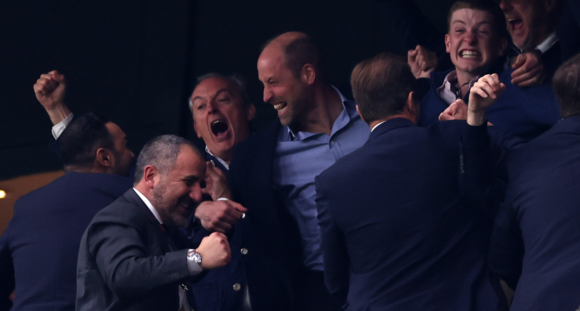 Prince William cheering with friends at an Aston Villa match