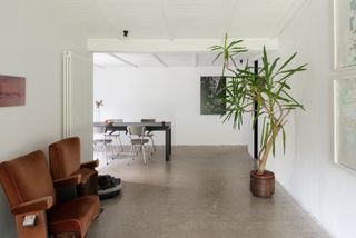 White open plan living spaces at house BPB by David Bulckaen contrast the black exterior