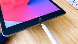 A first-generation Apple Pencil plugged into an iPad's Lightning port
