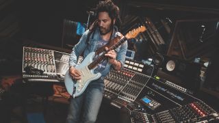 Lenny Kravitz plays a 1963 Fender Stratocaster with a Sonic Blue finish in the control room of his home studio