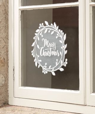 White Merry Christmas adhesive window sticker on window pane