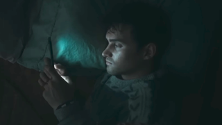 Michael Johnston doomscrolling in bed in Obsession