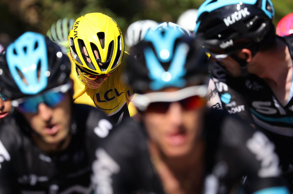 Chris Froome is surrounded by his Team Sky teammates
