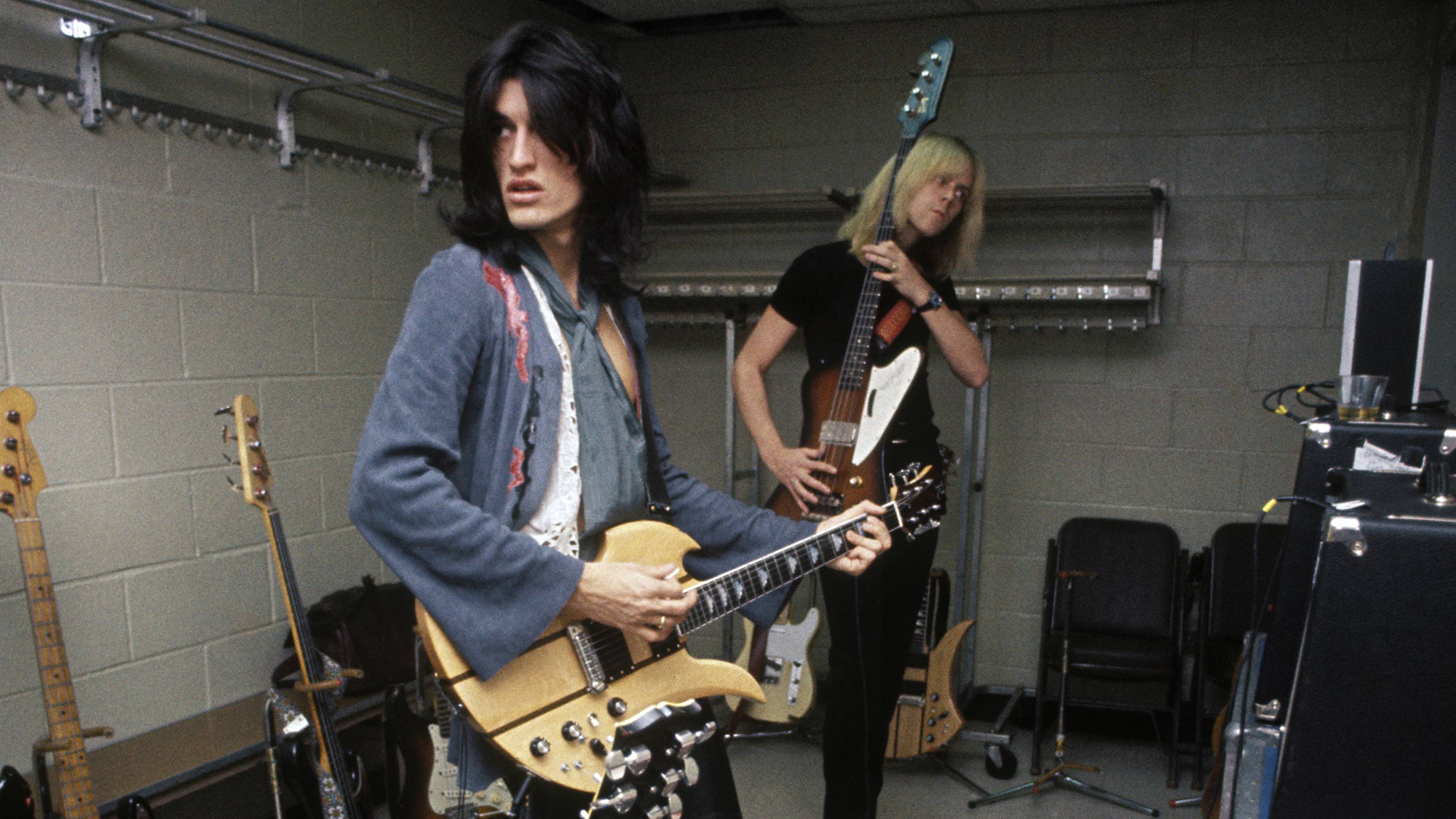 Joe Perry (left) and Tom Hamilton of Aerosmith backstage at Madison Square Garden, May 10, 1976. Perry is playing his BC Rich Mockingbird guitar