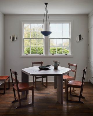 a hexagonal dining table in a hamptons home