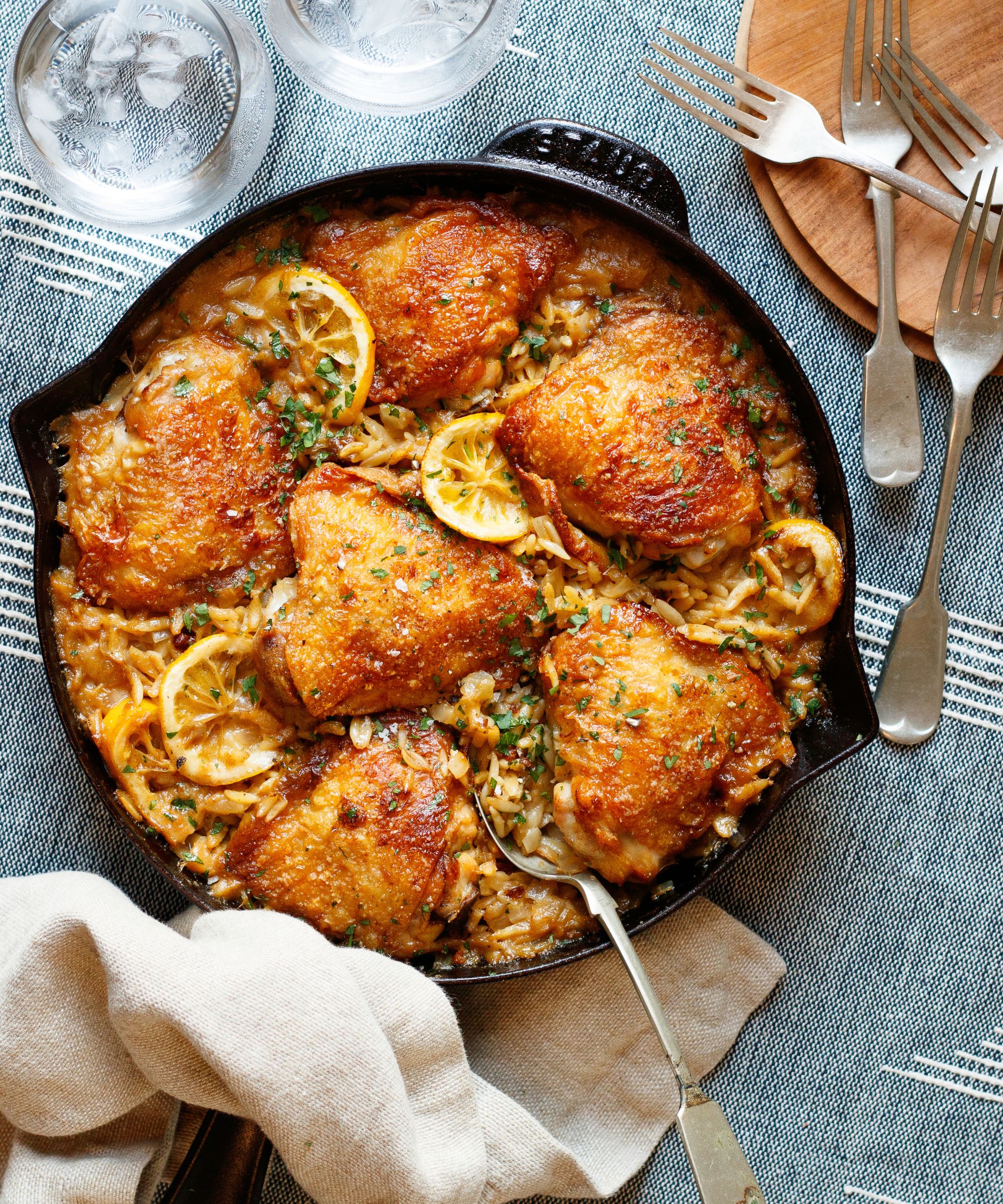 One-pot chicken and orzo recipe in a skillet pan on a table