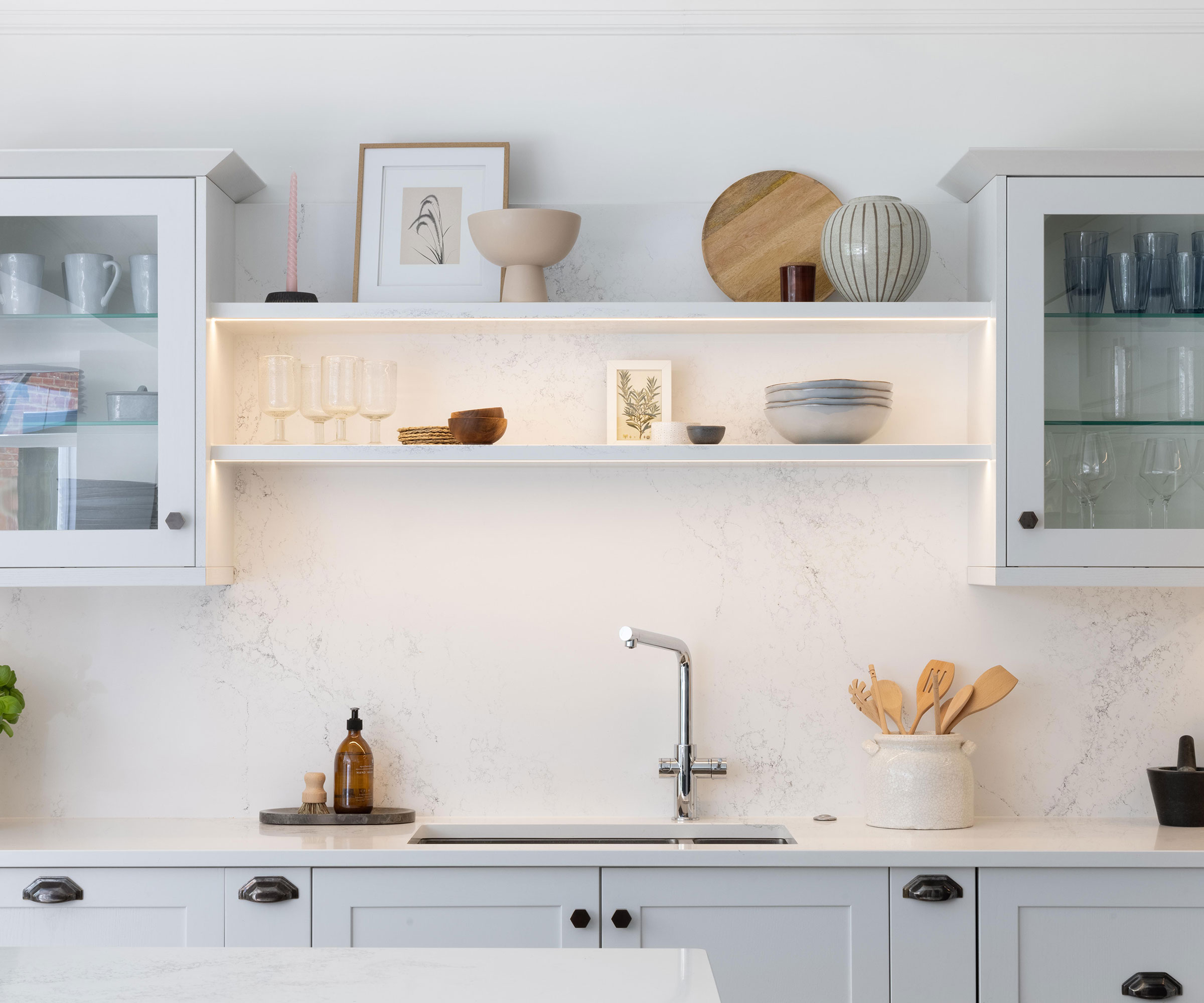 White Shaker kitchen with white work surfaces and slab splashback