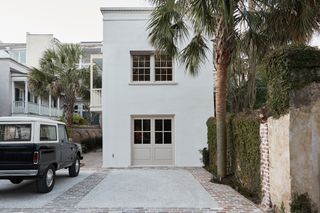 carriage house white exterior with car