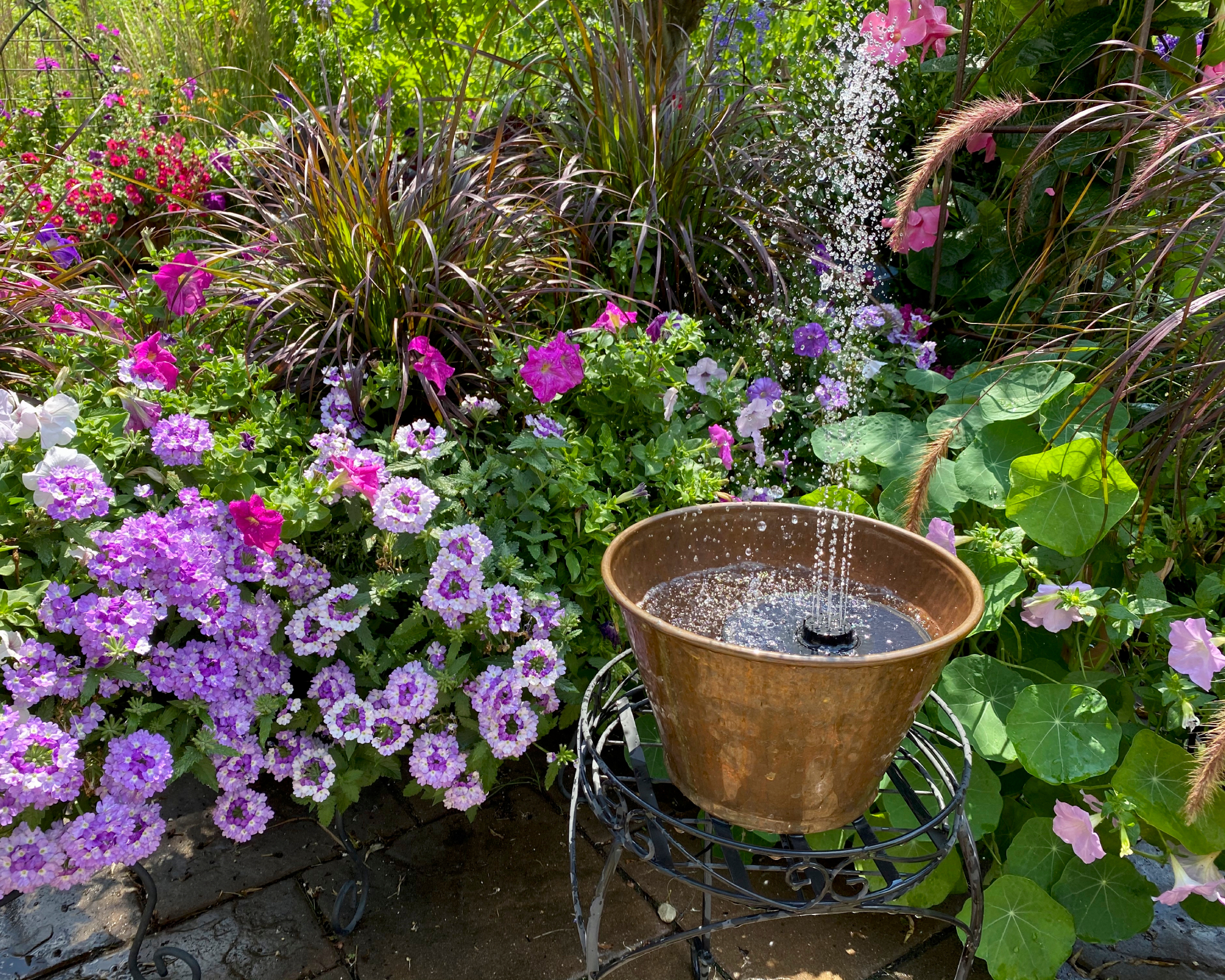 Patio feature created from container and floating solar fountain