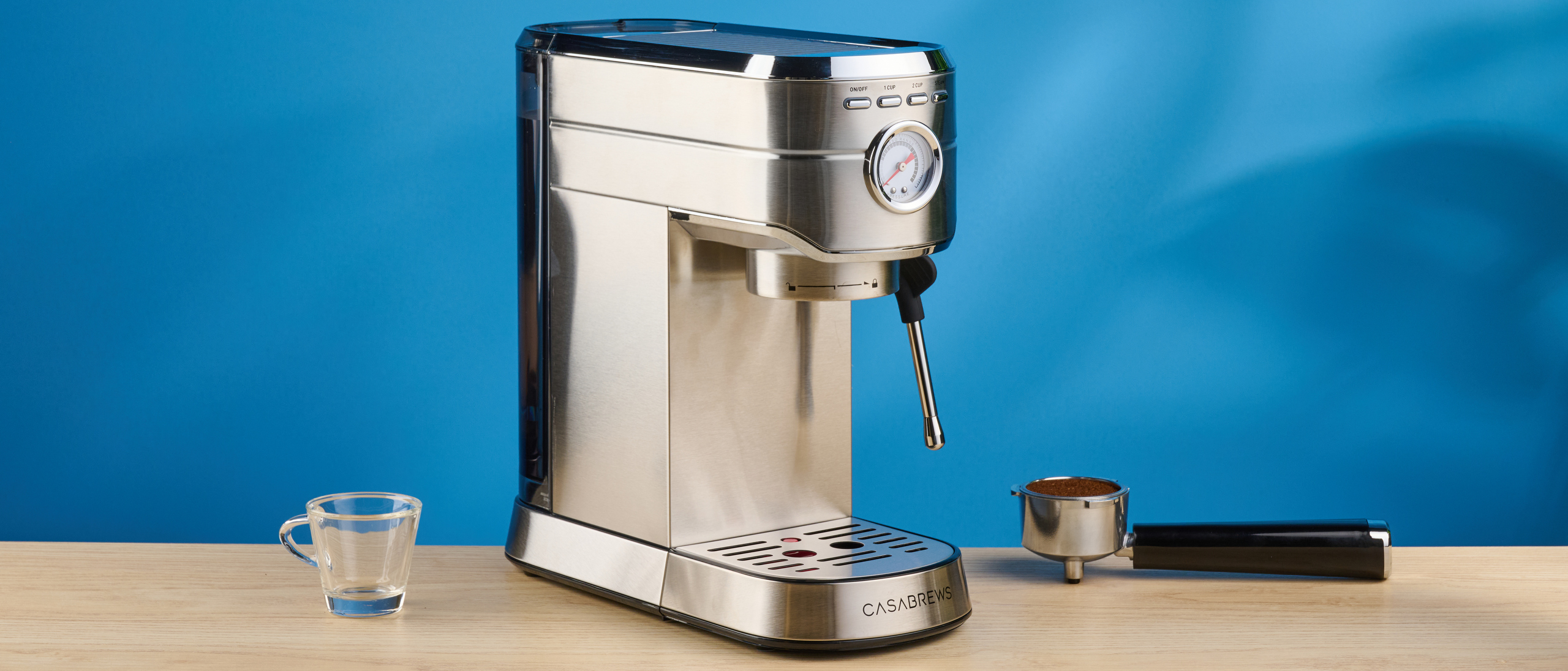 the casabrews cm5418 espresso machine in silver showing its steam wand and water tank and accessories