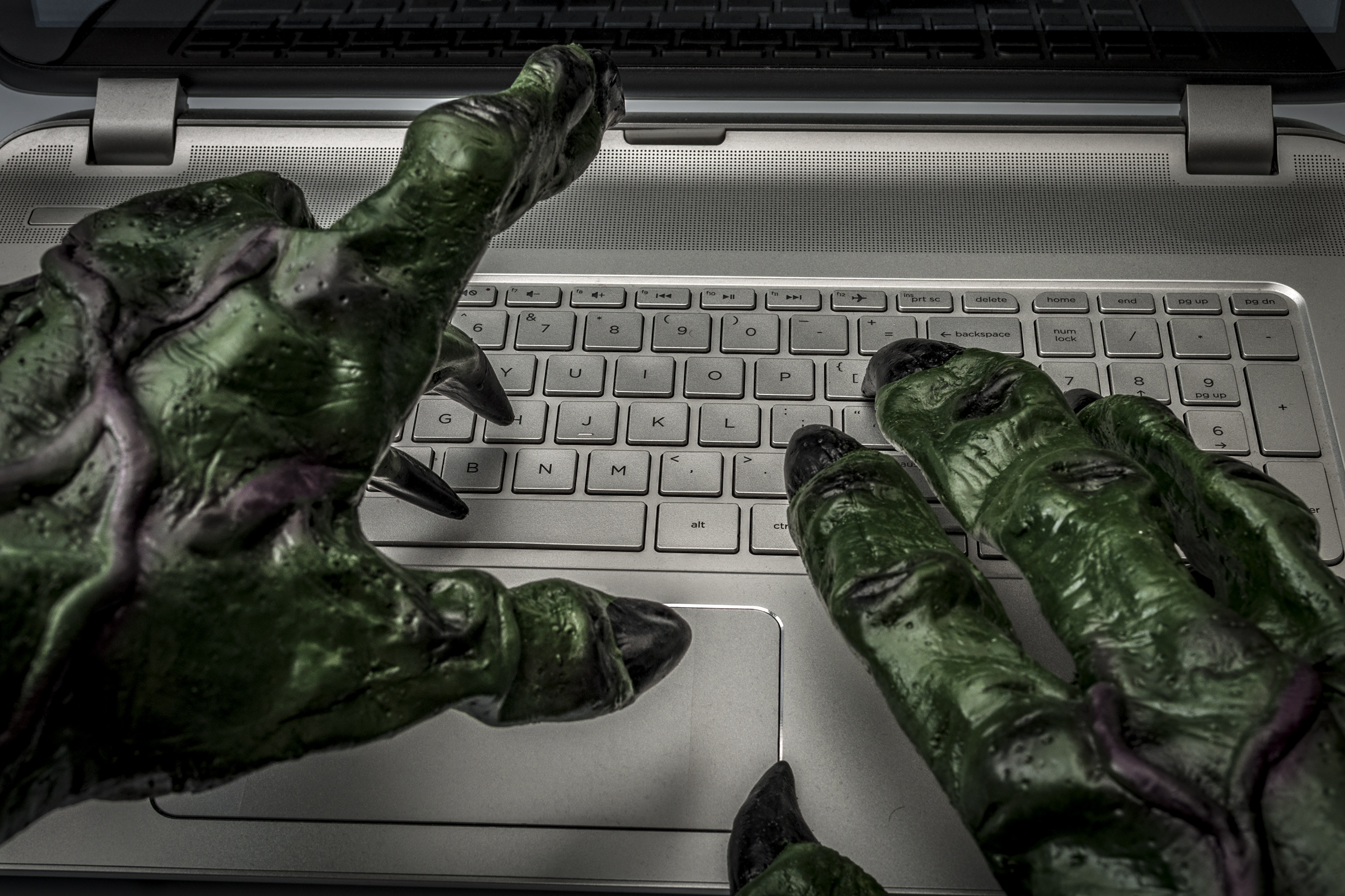 Monster hands typing on keyboard