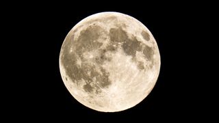 full moon names have a lot of significance here a large fully illuminated moon with large craters against a black background.