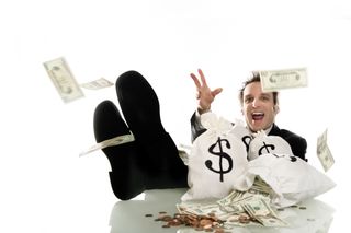 Businessman surrounded by money.