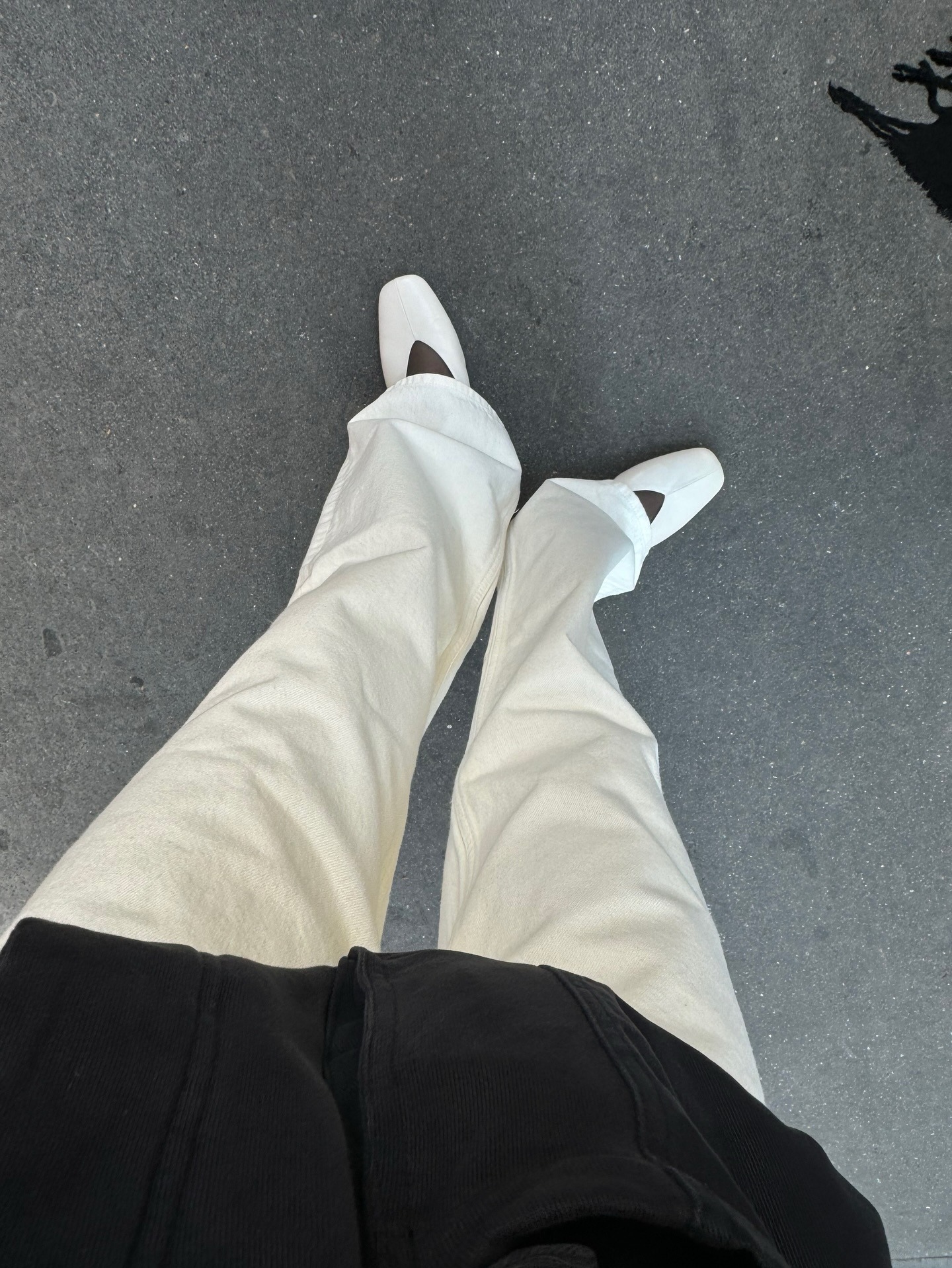 Woman wears white jeans outfit with white ballet flat shoes