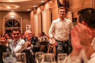 Warren Berguil looks on as Andre Greipel is called forward at the Fortuneo-Samsic dinner