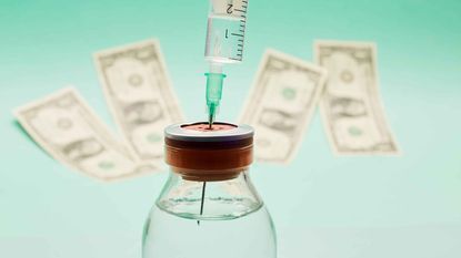 photo of a needle into a bottle of medicine with dollar bills in the background