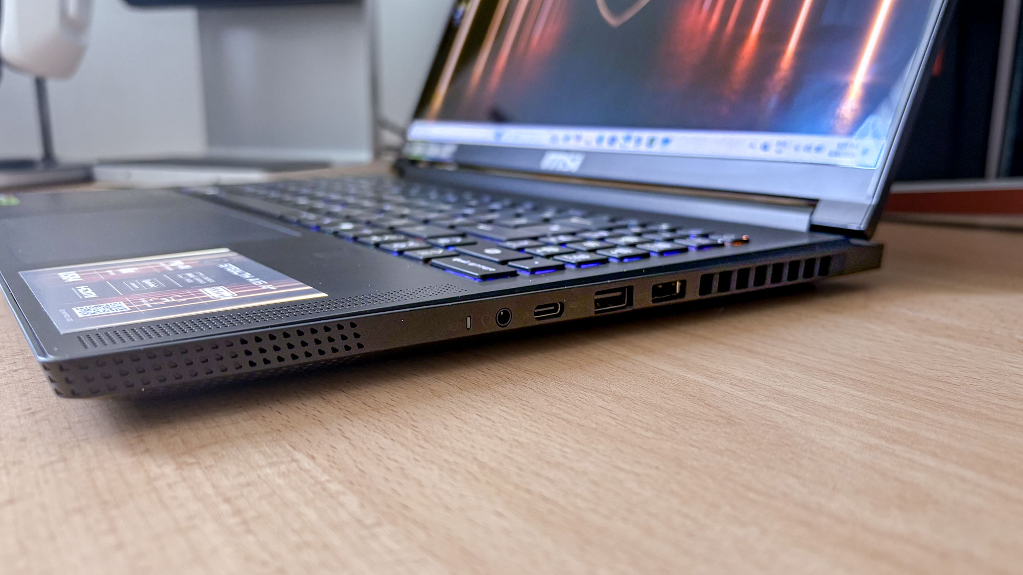 MSI Stealth A16 AI+ on desk with side view