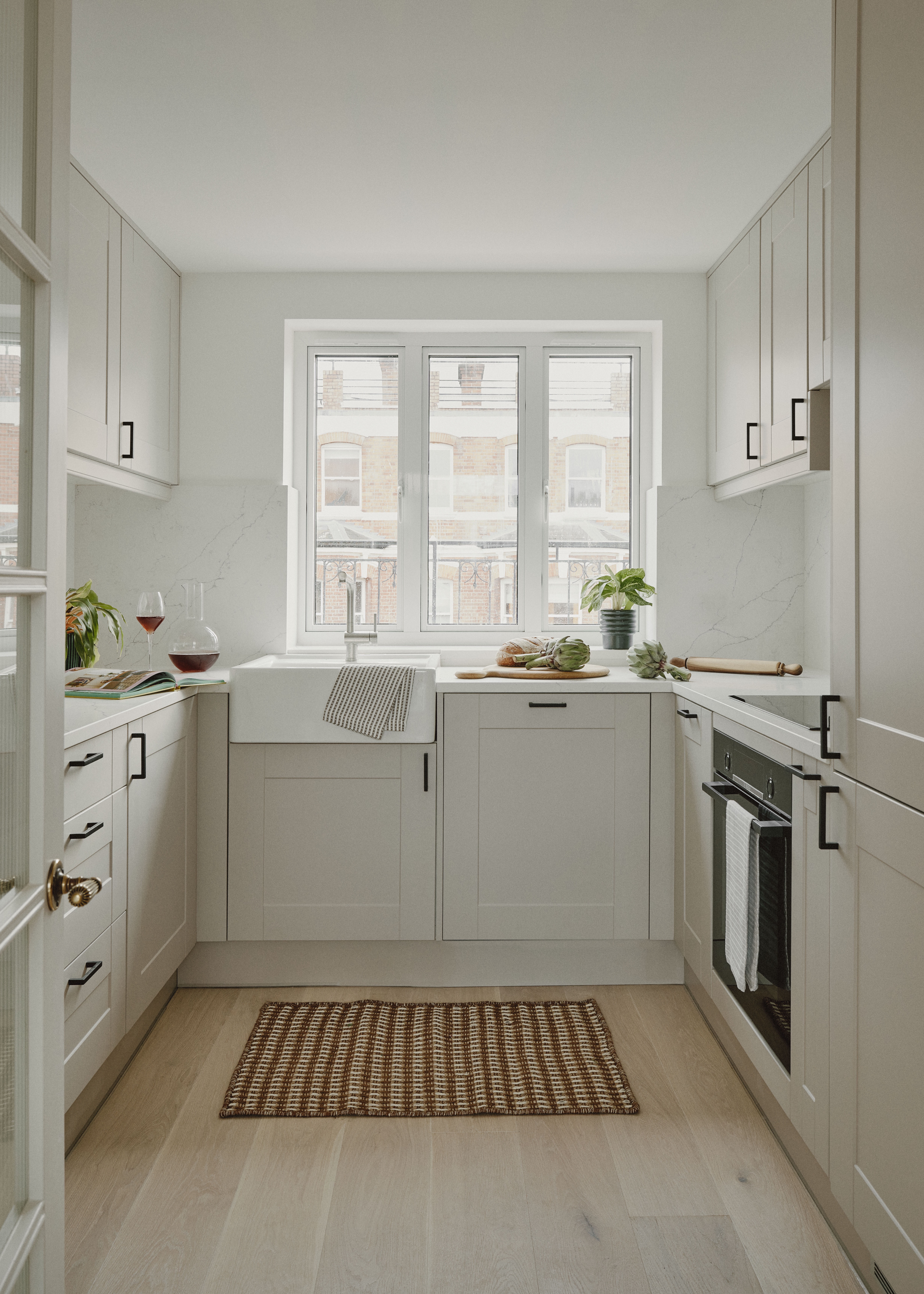 small cream kitchen with oak flooring