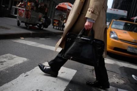 A man carries a briefcase