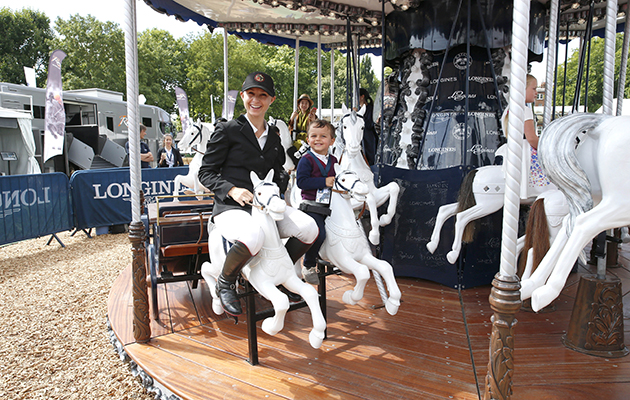 America’s Georgina Bloomberg opts for a different sized mount to enjoy the Longines carousel with her son Jasper