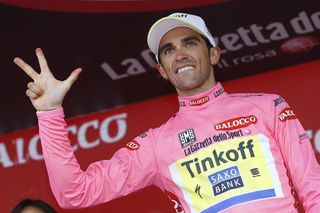 Alberto Contador signals his belief that he will be the winner of three Giro's on Sunday in Milano.