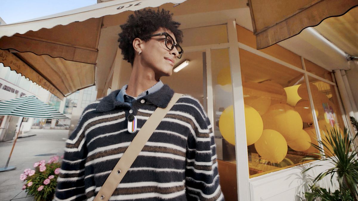 Insta360 Go 3S Retro edition action camera, attached to a person's sweater