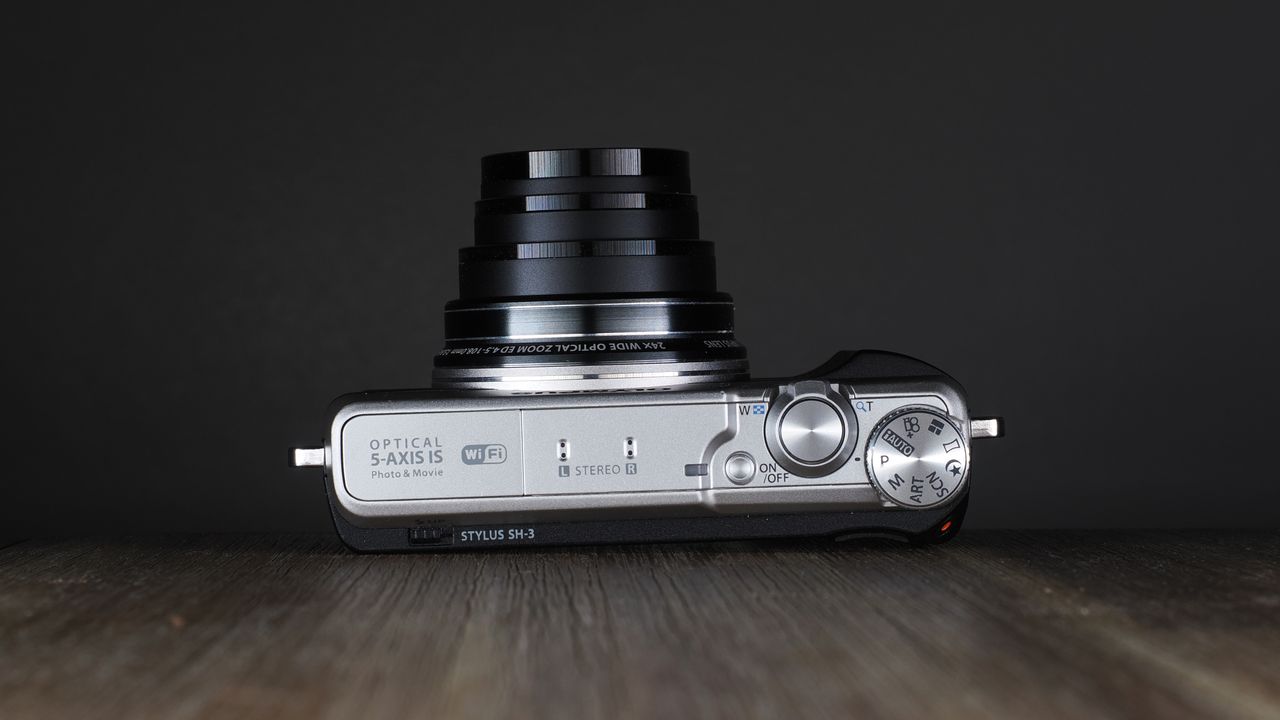Olympus Stylus SH-3 on a wooden surface