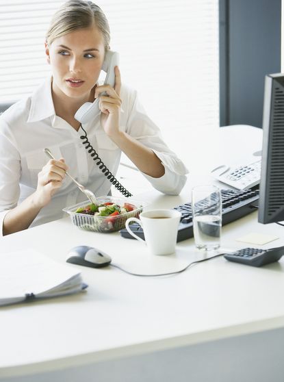 woman eating Lunch at desk 