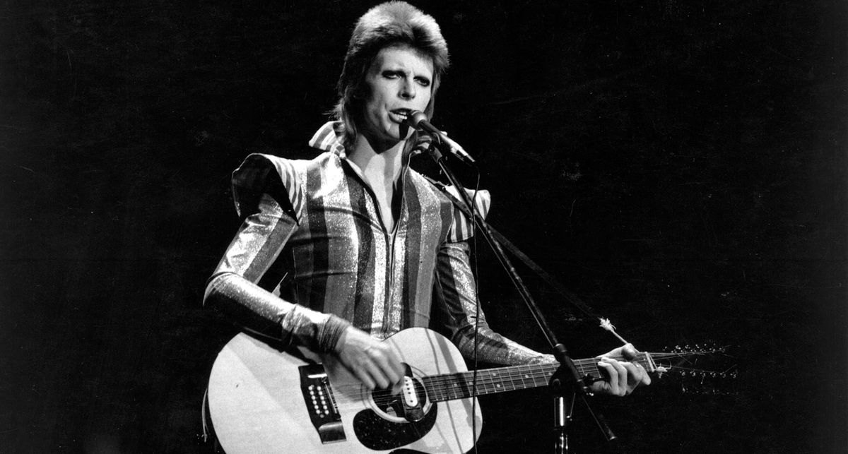 David Bowie as Ziggy Stardust plays an acoustic with a soundhole mounted pickup