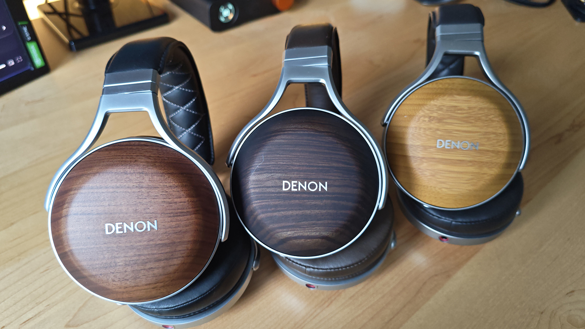 The Denon AH-D5200 and other headphones, photographed on a home desktop. 