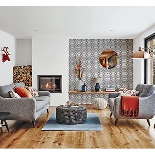 living area with wooden floor and grey sofa and white floor
