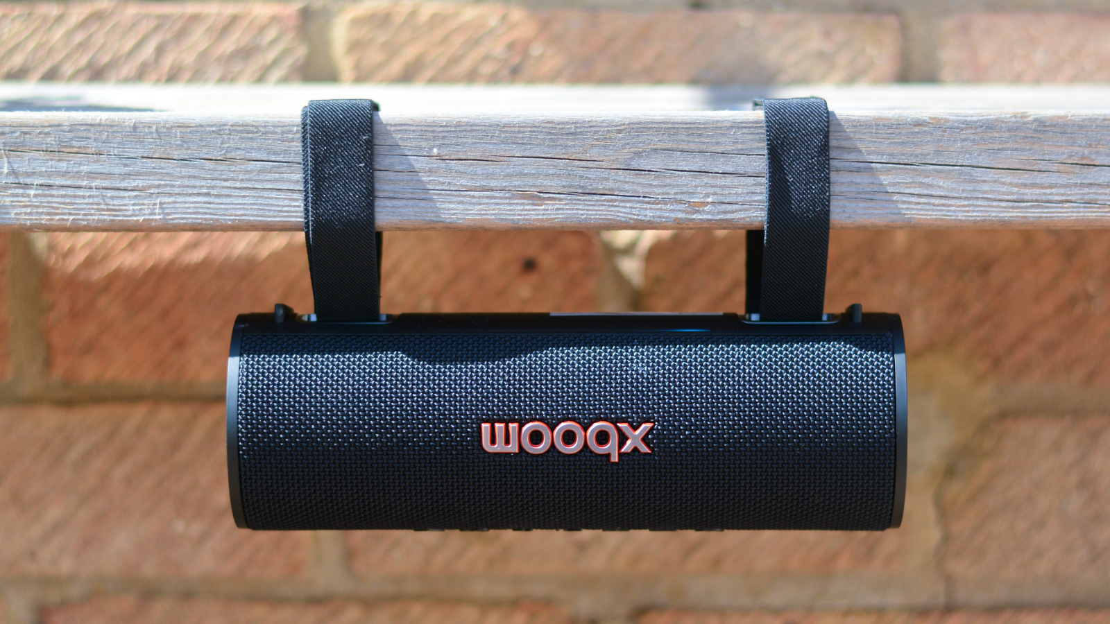 LG xboom Grab Bluetooth speaker in an outdoor setting