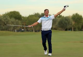 Bryson DeChambeau waves his cap in the air after winning the 2018 Shriners Hospitals For Children Open