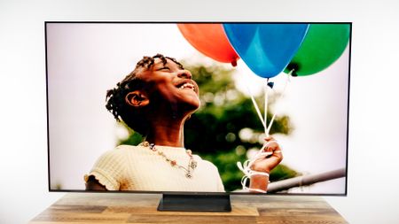 TCL QM7L 75-inch TV on a desk