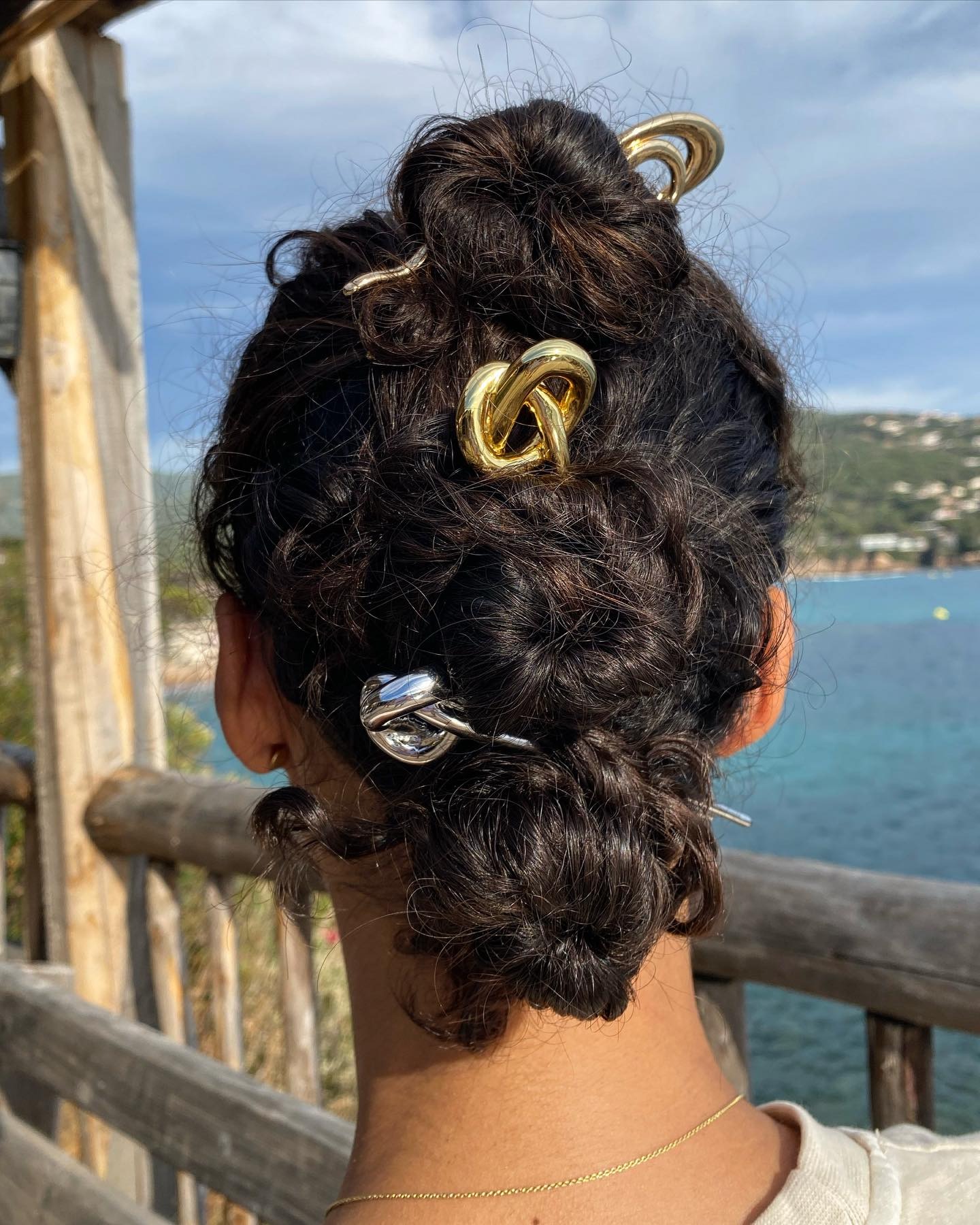 A picture of an updo hairstyle with multiple French pins
