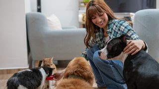 Woman with variety of pets in her home