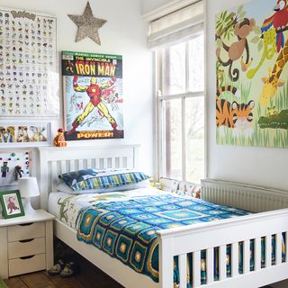 childrens bedroom with white wall and white wooden bed with wooden flooring and poster on wall