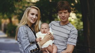 Mick Jagger and Jerry Hall with one of their children, circa 1990