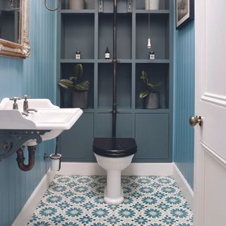 Downstairs cloakroom with blue patterned tile flooring