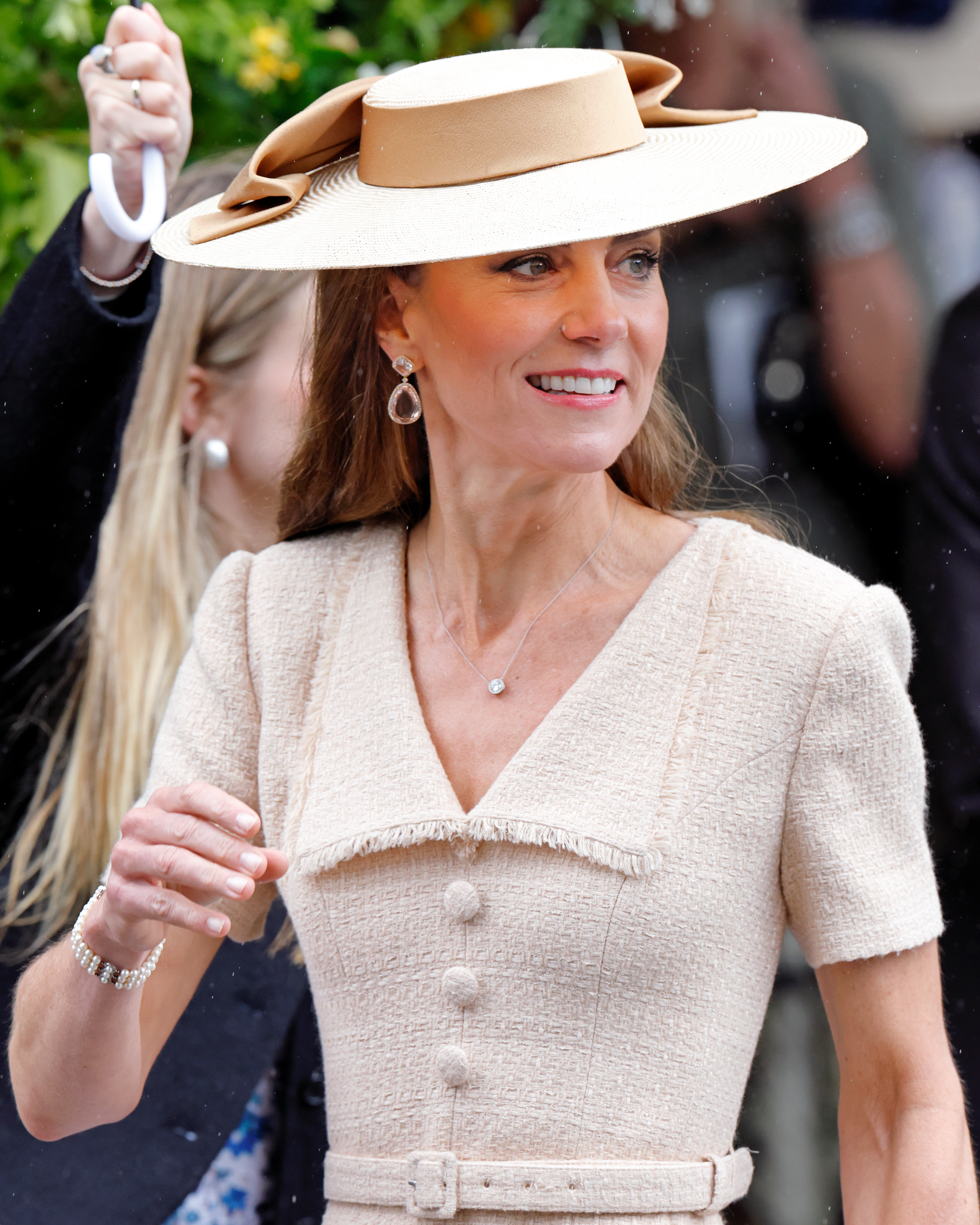 Kate Middleton wearing a beige dress and boater hat