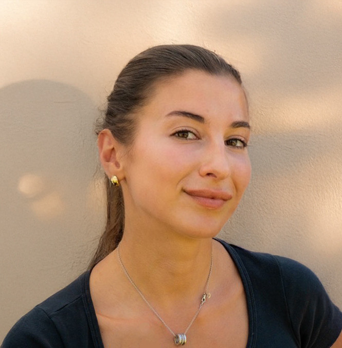 Kira Piskalova, a white woman with brown hair and brown eyes in a dark t-shirt