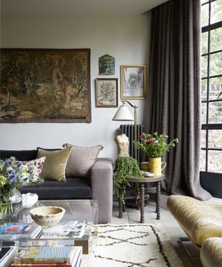Living room by Cave interiors with a gallery wall and collectables
