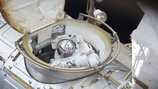 NASA astronaut Ricky Arnold emerges from the Quest airlock, kicking off a 6 hour and 49 minute-long spacewalk on June 14, 2018.